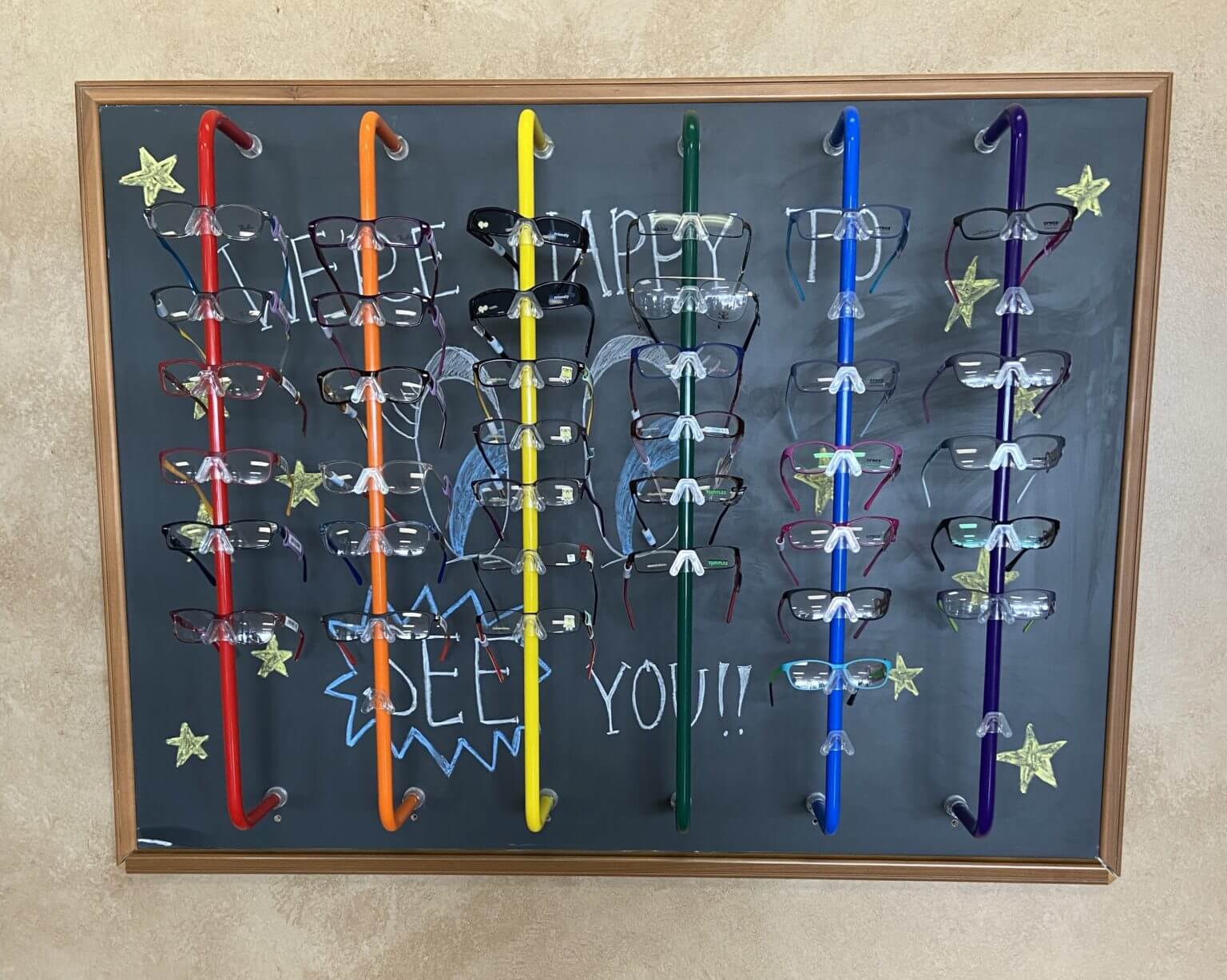 Colourful kids’ frame wall at Briargrove Eye Center