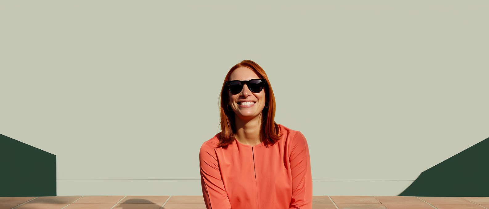 A woman in sunglasses looking up into the sun