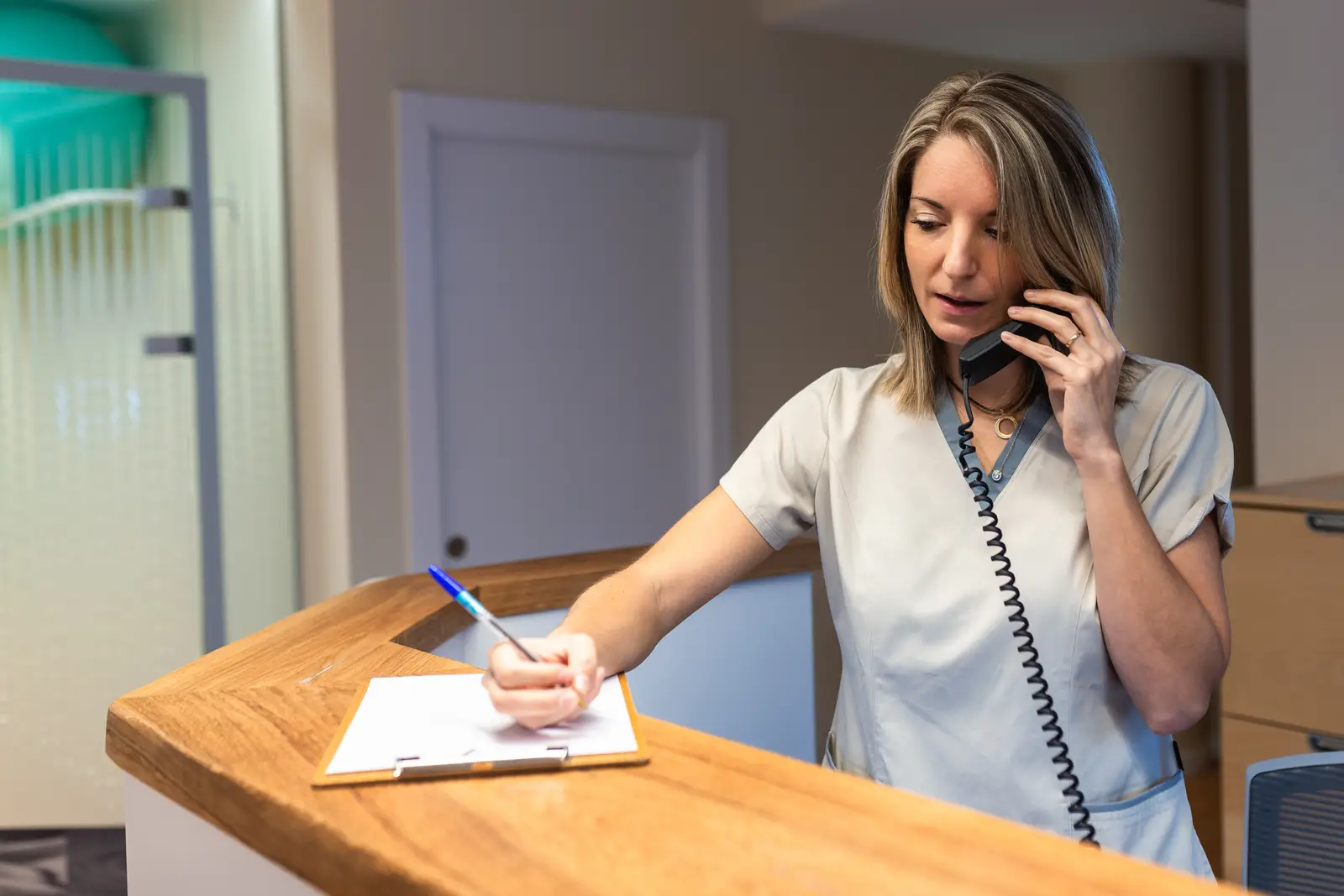 Woman writing on clipboard