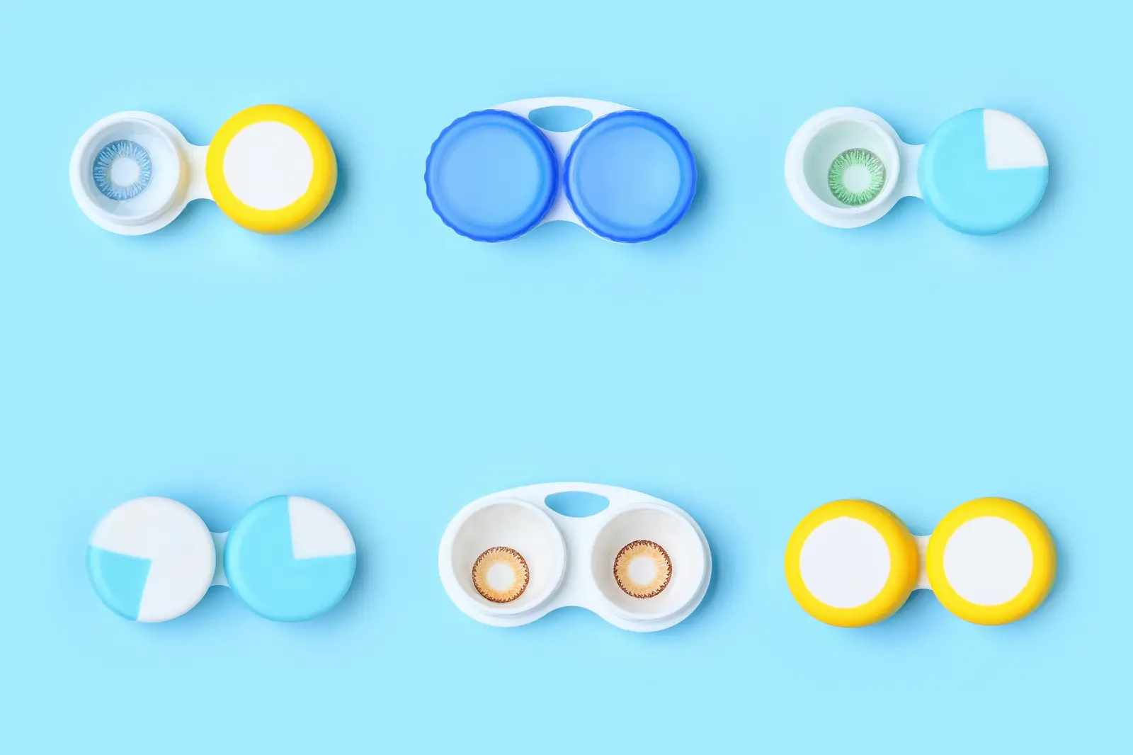 Six colored contact lenses in containers against a blue background
